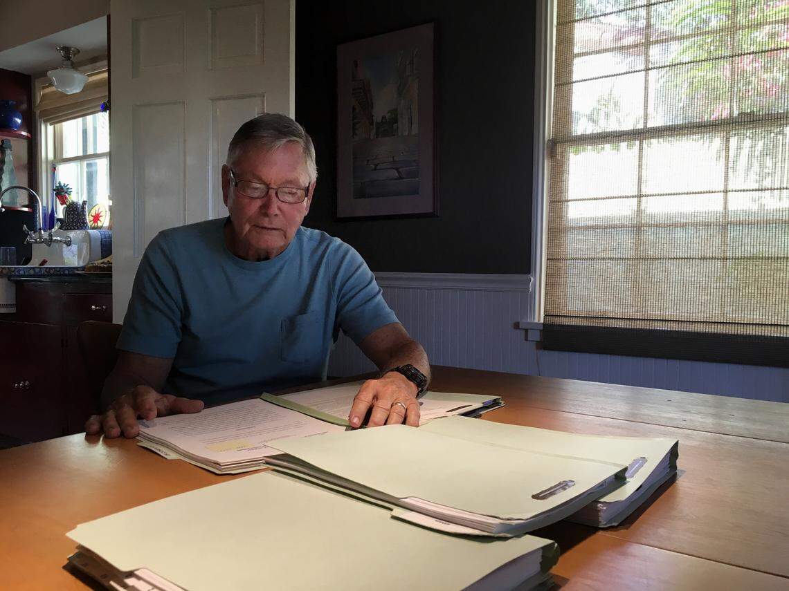 Former North Bay Village city manager Frank Rollason pores over files of emails, ethics complaints and reports he collected about Mayor Connie Leon-Kreps.