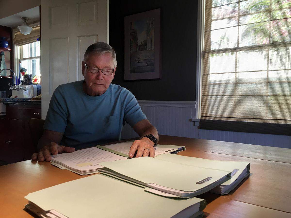Former North Bay Village city manager Frank Rollason pores over files of emails, ethics complaints and reports he collected about Mayor Connie Leon-Kreps.