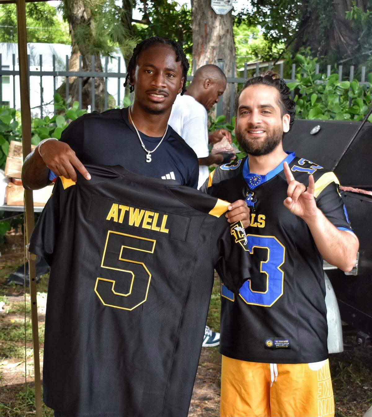 Anthony Castro, founder and CEO of All Stars Miami, poses with Los Angeles Rams receiver Tutu Atwell after giving him a customized Miami Northwestern jersey. A 2021 NFL Draft pick, Atwell starred at Northwestern before attending University of Louisville.