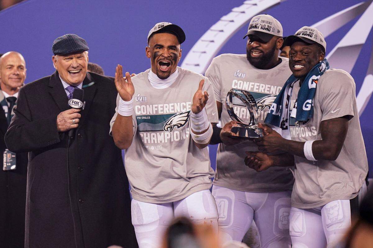 FILE - Terry Bradshaw, left, stands on stage with Philadelphia Eagles players from left, Jalen Hurts, Fletcher Cox and A.J. Brown after the NFC Championship NFL football game between the Philadelphia Eagles and the San Francisco 49ers on Sunday, Jan. 29, 2023, in Philadelphia. Fox says it has sold out all of its Super Bowl 57 ad space as of the end of January. The big game between the Kansas City Chiefs and the Philadelphia Eagles takes place on Sunday, Feb. 12. (AP Photo/Seth Wenig, File)