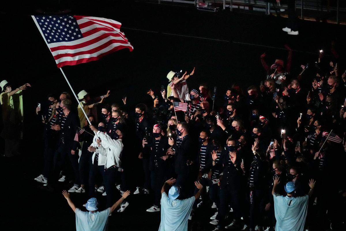 Sue Bird and Eddy Alvarez, of the United States of America, carry their country’s flag during the opening ceremony in the Olympic Stadium at the 2020 Summer Olympics, Friday, July 23, 2021, in Tokyo, Japan.