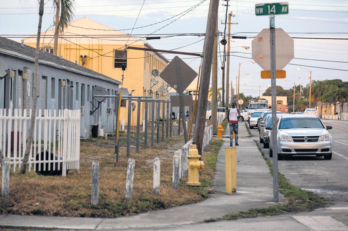 A man walks down Northwest 63rd Street and 14th Avenue in Liberty Square earlier this month.