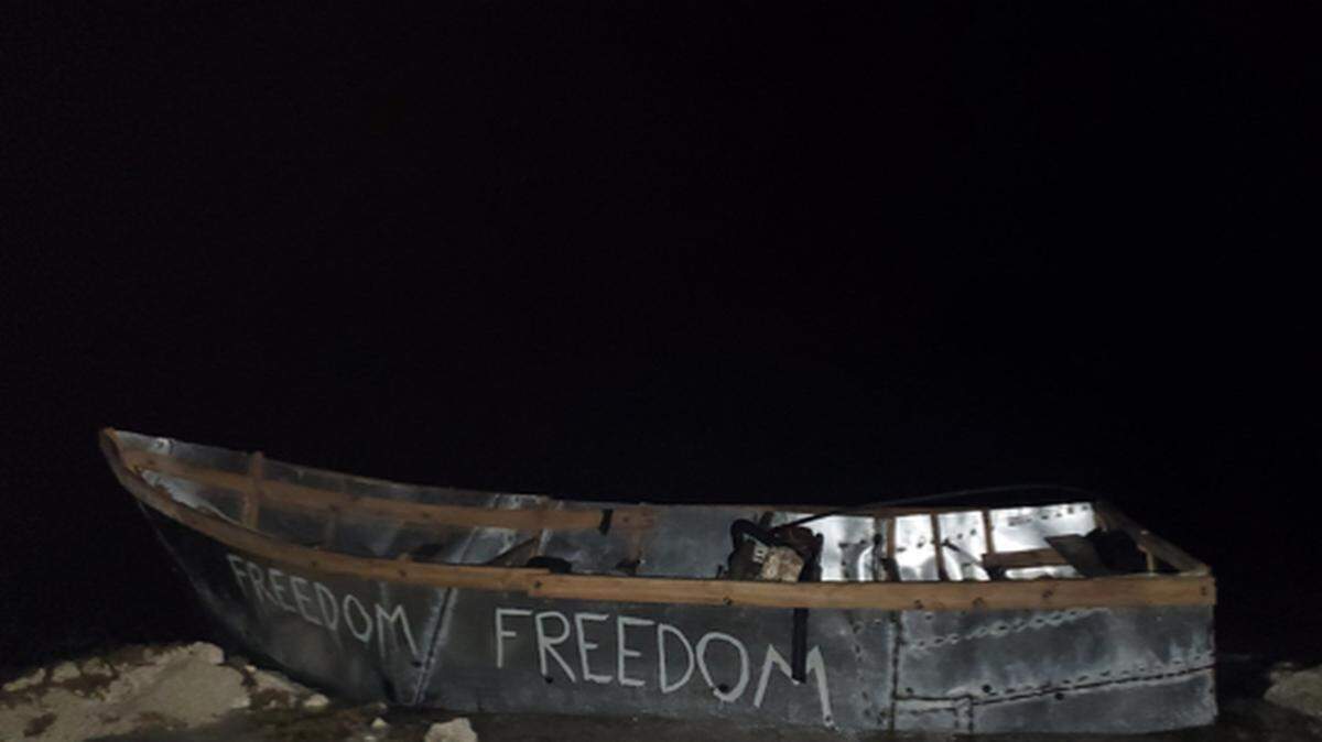 A Cuban migrant boat with the word ‘Freedom’ written on its side is beached on the shore in Key West Wednesday, May 25, 2022.