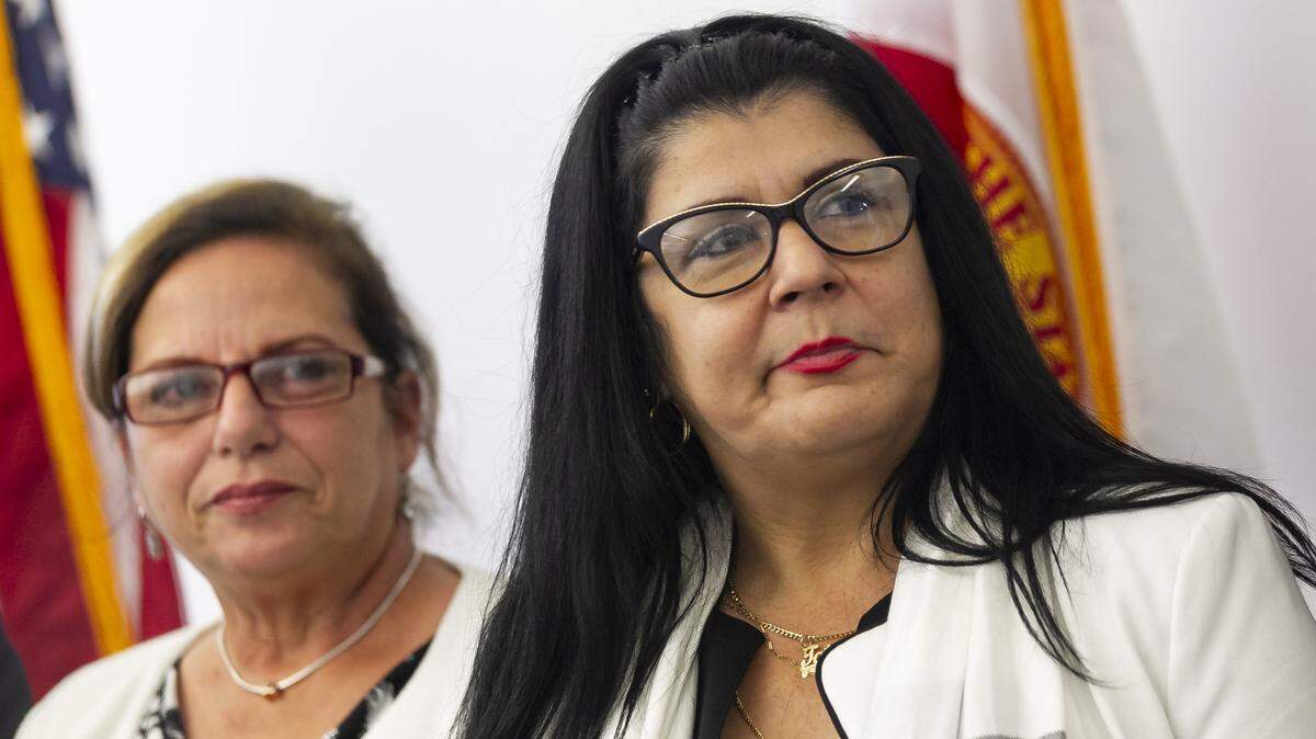 Cuban doctors Ramona Matos, left, and Tatiana Caraballo attend a press conference Wednesday in Doral announcing a federal lawsuit against the Pan American Health Organization for its role in trafficking thousands of Cuban doctors and other health care professionals.