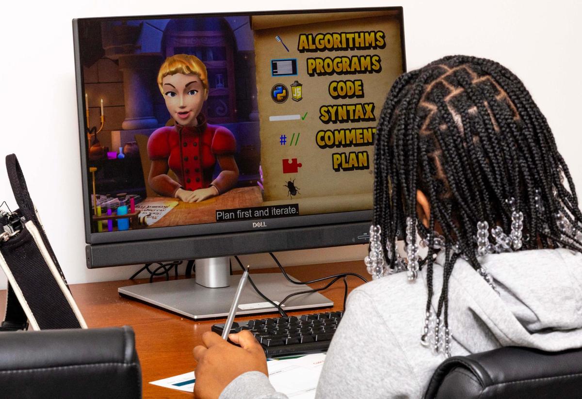 A student takes notes during a coding workshop sponsored by Miami Gardens’ Department of Educational Development.
