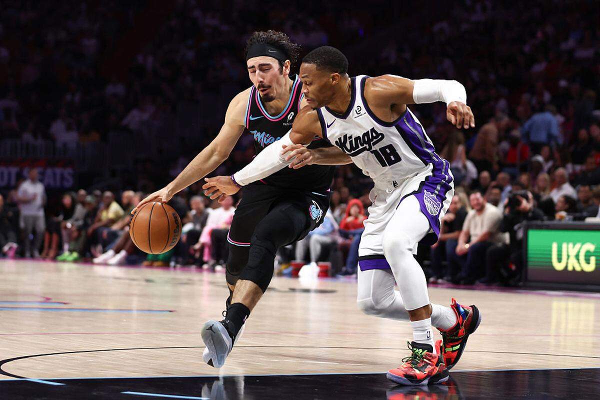 Jaime Jaquez Jr. #11 of the Miami Heat drives against Russell Westbrook #18 of the Sacramento Kings during the third quarter of the game at Kaseya Center on December 06, 2025 in Miami.