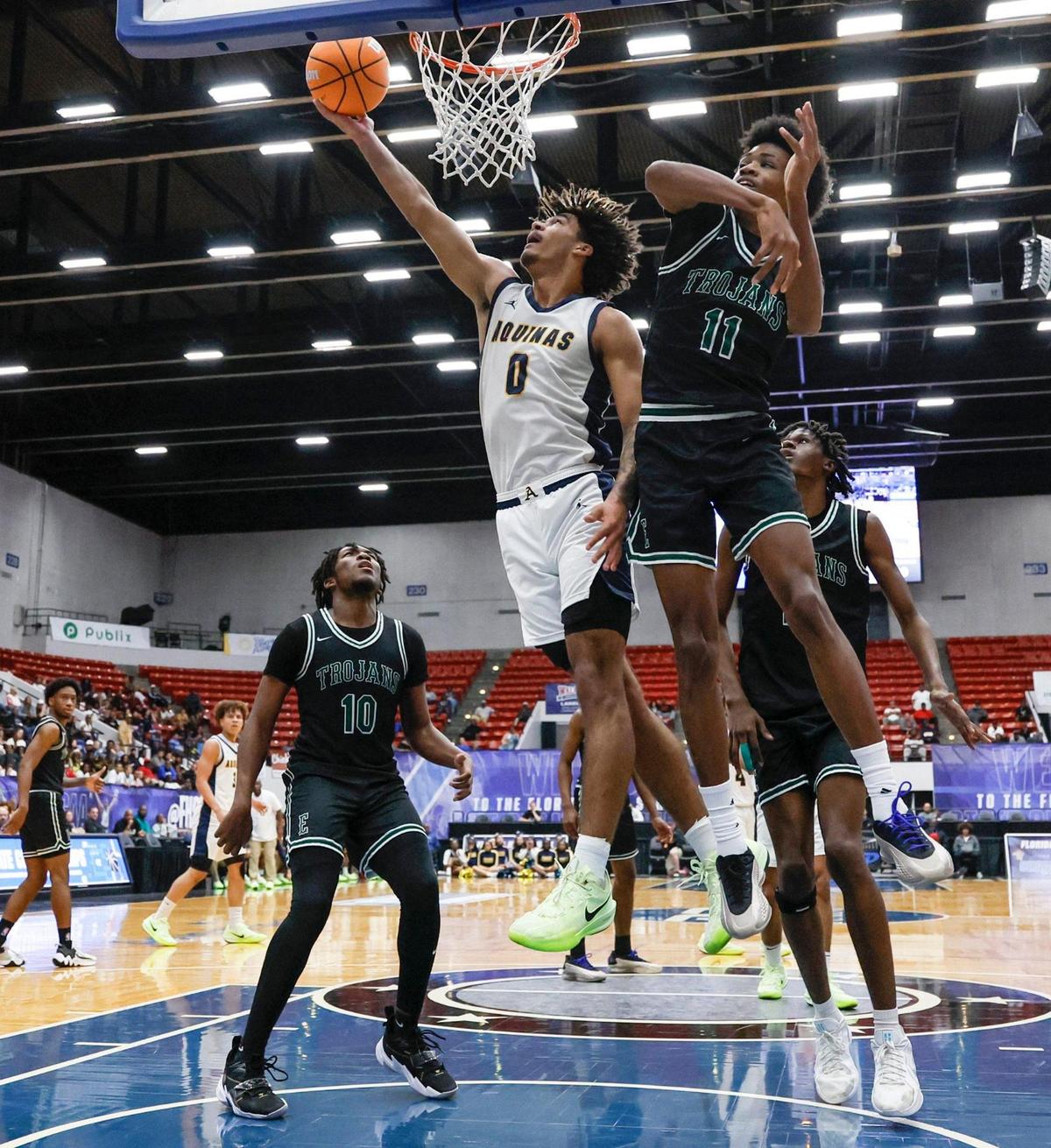 St. Thomas Aquinas Raiders Dwayne Wimbley Jr. (0) scores against Evans High School’s David Rushing (11) in the first half of the FHSAA Class 6A Boys High School Basketball State Championship at the RP Funding Center in Lakeland, Florida on Saturday, March 8, 2025.
