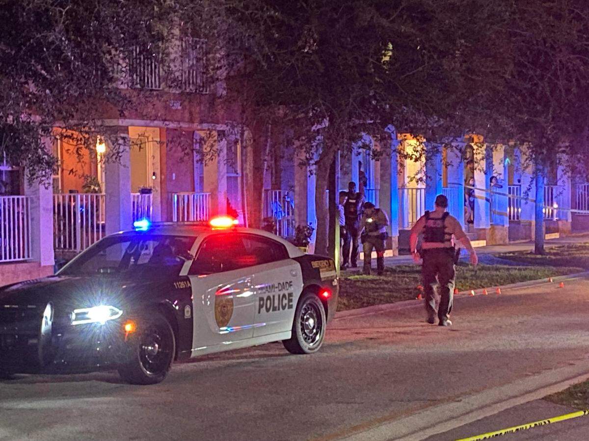 Miami-Dade County police officers investigate outside a townhouse at SW 109th Avenue and 240th Street Saturday, Oct. 20, 2024. Multiple shots were fired outside the home