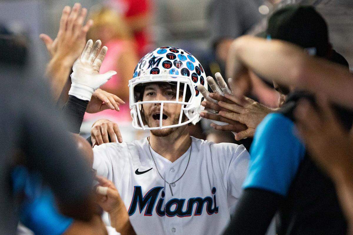 Miami Marlins third baseman Brian Anderson (15) celebrates in the dugout after hitting a home run during the fourth inning of an MLB game against the Los Angeles Dodgers at loanDepot park in Miami, Florida, on Sunday, August 28, 2022.