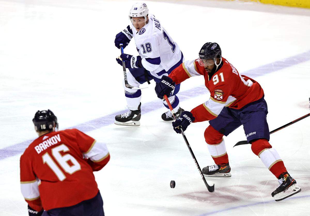 Tampa Bay Lightning left wing Ondrej Palat (18) defends as Florida Panthers left wing Anthony Duclair (91) passes the puck to teammate Panthers center Aleksander Barkov (16) during the first period of game 1 of their first round NHL Stanley Cup series at the BB&T Center on Sunday, May 16, 2021 in Sunrise, Fl.