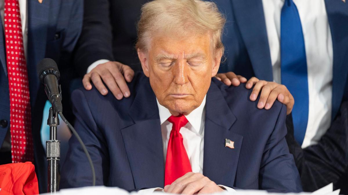 President Donald Trump prays during a roundtable discussion with local Latino leaders at Trump National Doral Miami on Tuesday, Oct. 22, 2024, in Doral, Fla.