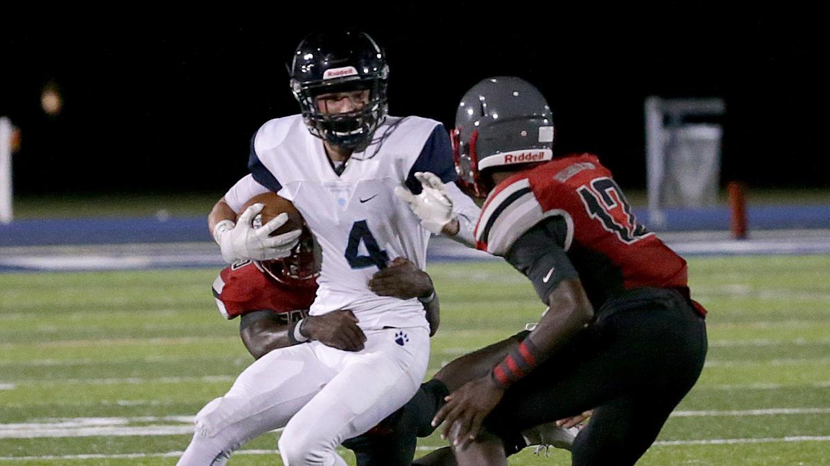 Palmetto’s Kane Vandemark (WR), drives against Cavaliers’ linebackers Aden Martinez (QB-WR) #17 and Fashawn Renojuste #25, during the first quarter of the Coral Gables Cavaliers vs Miami Palmetto Varsity high school football game at Tropical Park on Thursday, September 20th, 2018.