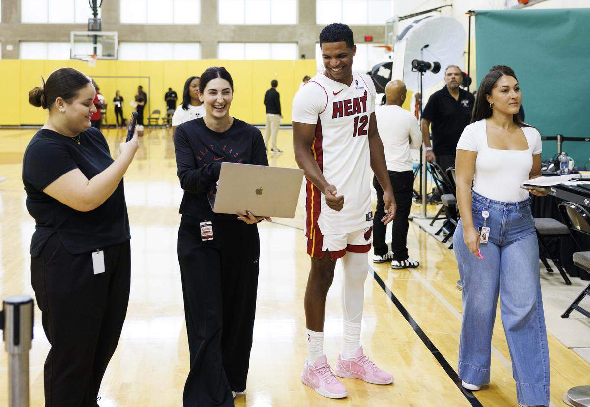 Dru Smith (12) laughs with HEAT staff members during the Miami HEAT Media Day on Monday, Sept. 29, 2025, at the Kaseya Center in downtown Miami, Fla.