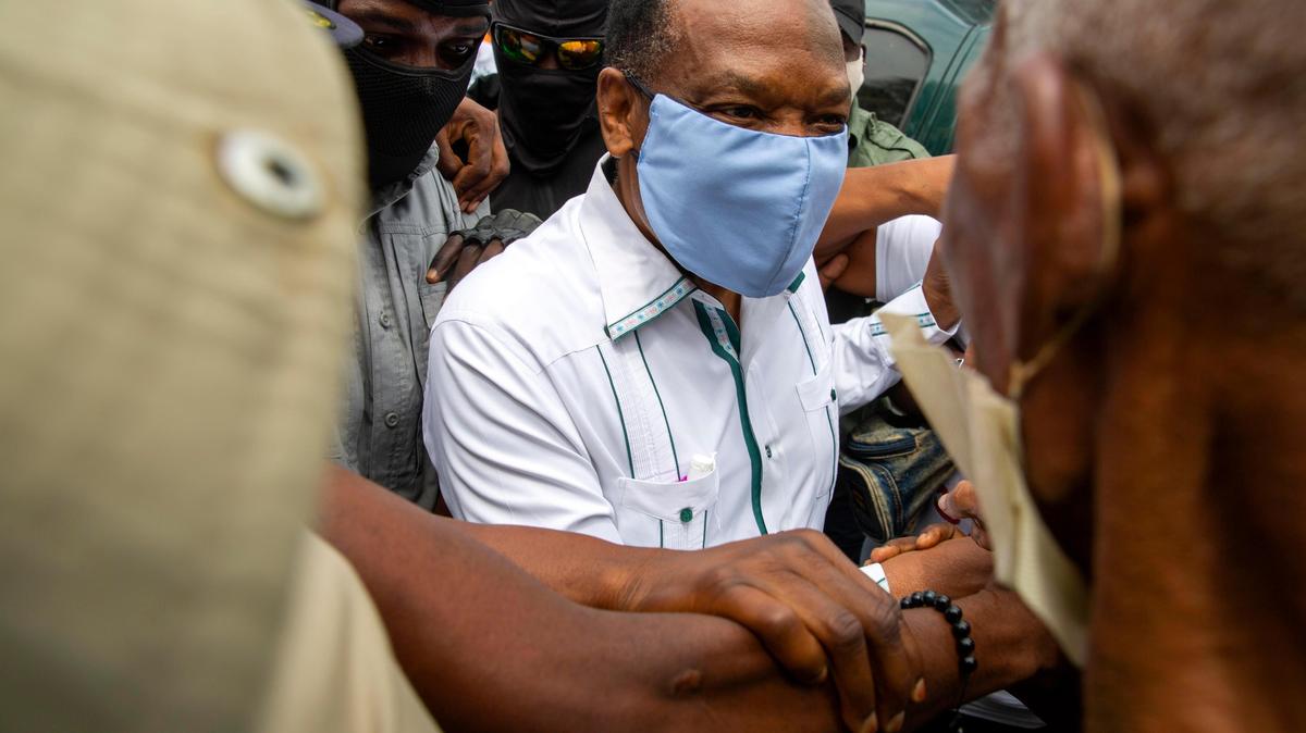 Yves Jean-Bart, president of the Haitian Football Federation, wearing a light blue protective face mask, arrives at a courthouse for a hearing regarding allegations that he abused female athletes at the country’s national training center, in Croix-des-Bouquets, Haiti, Thursday, May 21, 2020. Several players and former players have come forward and accused him of sexual misconduct after he threatened to remove them from the team if they did not accept his advances.