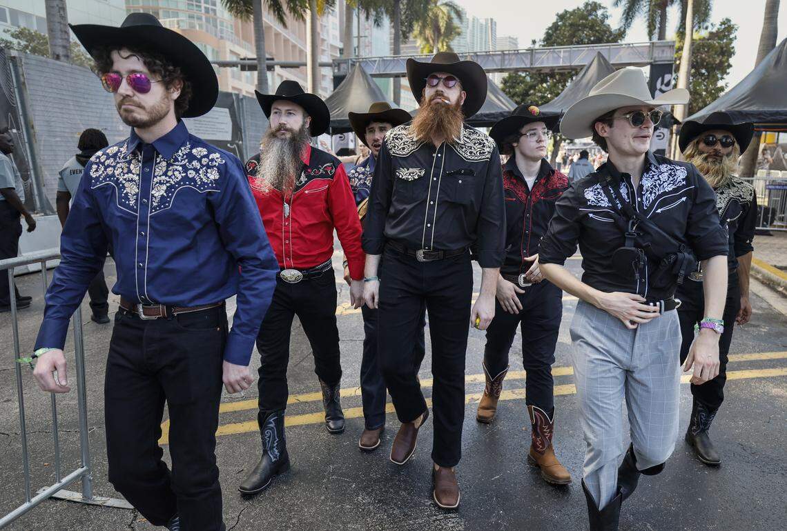 Michael Schmitt, at center, arrives with his Miami co-workers dressed as cowboys to Ultra Music Festival in Miami, Florida, on Friday, March 27, 2026.