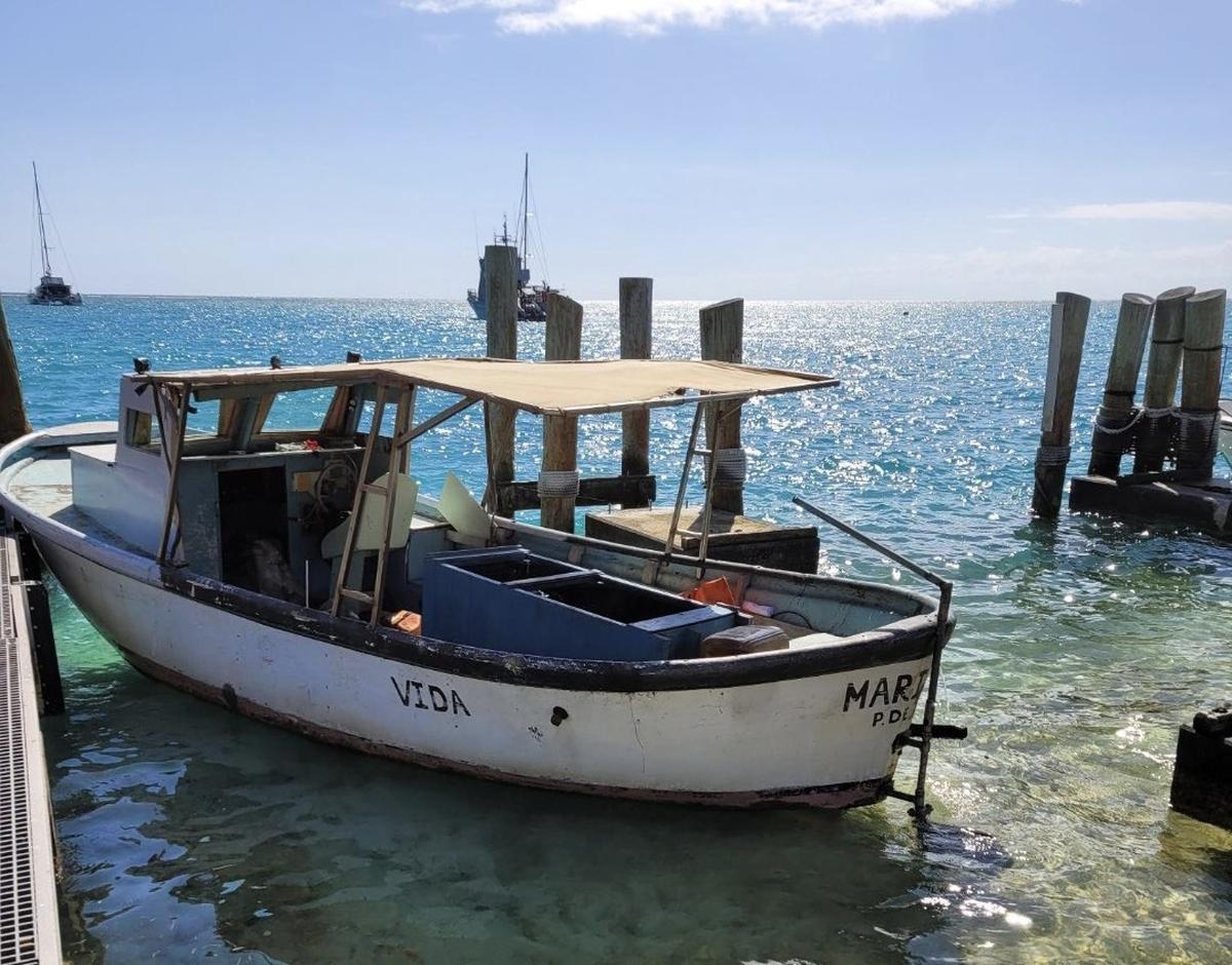A small Cuban fishing vessel is docked in Dry Tortugas National Park Thursday, Feb. 2, 2023. The Border Patrol said 19 adults and 11 children came to shore on the boat.