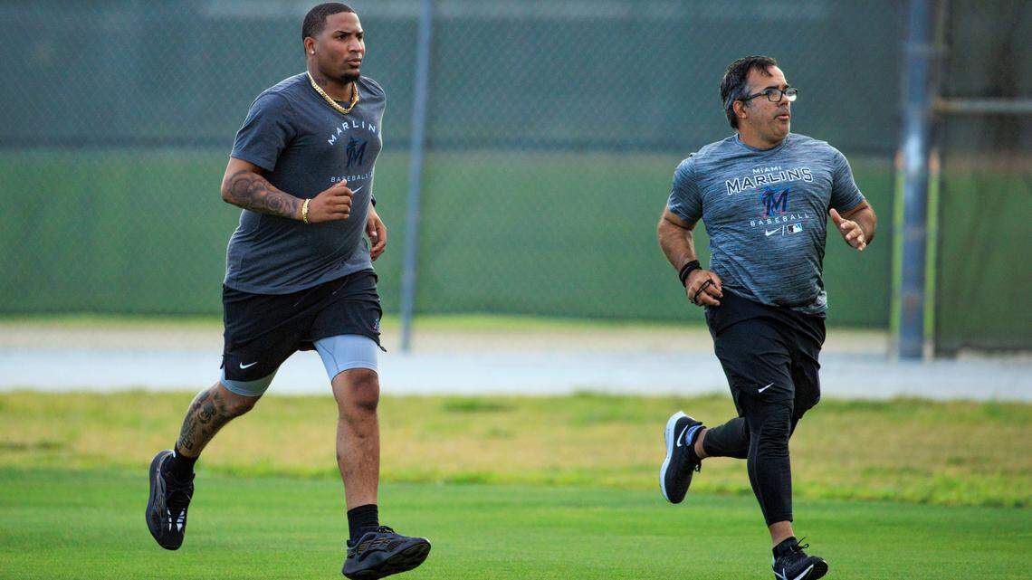 Miami Marlins pitcher Sixto Sanchez runs with team rehab strength & conditioning coordinator Alexander Pons during their spring training workout at Roger Dean Stadium on Tuesday, March 15, 2022 in Jupiter, FL.