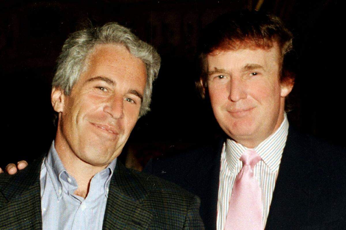 Jeffrey Epstein, left, and Donald Trump appear together at the Mar-a-Lago estate in Palm Beach, Fla., in 1997. Emails released Wednesday by the House Oversight Committee say Trump spent “hours” with a victim at Epstein’s home and “knew about the girls.”