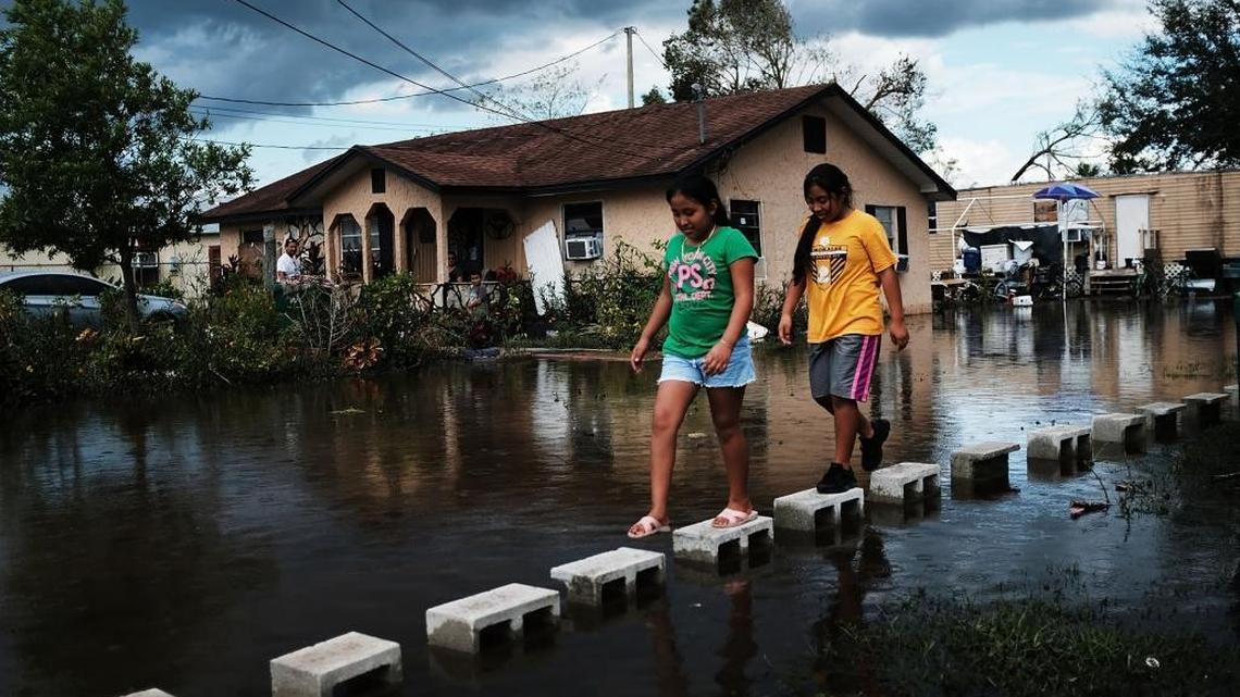 Children walk through flooded streets in the rural migrant worker town of Immokalee, which was especially hard hit by Hurricane Irma. Hurricane Irma made landfall near Naples after inundating the Florida Keys. Electricity was out in much of the region with extensive flooding.