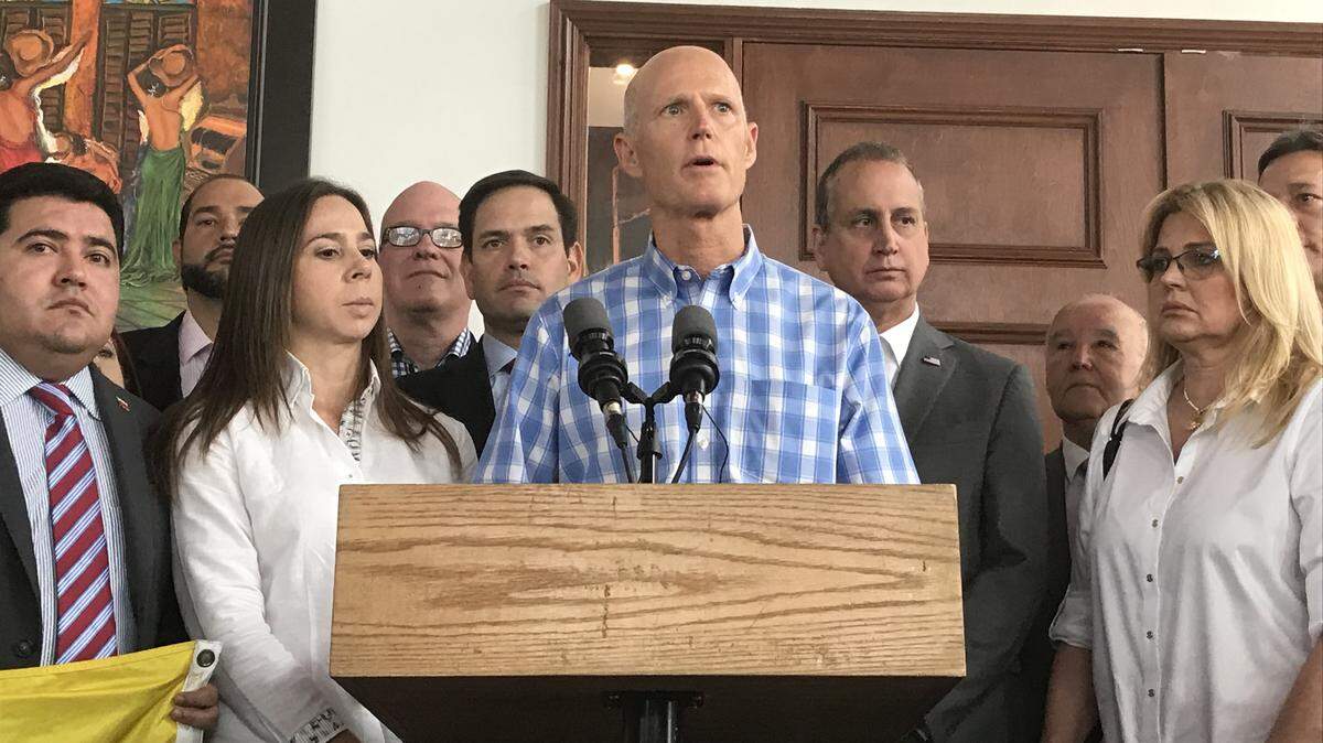 U.S. Sen. Rick Scott (center) stood with U.S. Sen. Marco Rubio (back left) and U.S. Rep. Mario Diaz-Balart (back right) during a press conference at Las Vegas Cuban Cuisine in downtown Doral Friday to talk about the efforts by opposition leader Juan Guaido to oust Venezuelan ruler Nicolas Maduro.