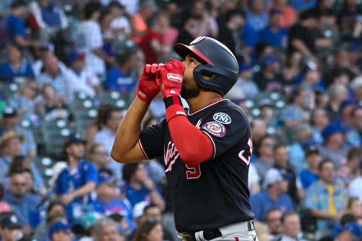Washington Nationals third baseman Jeimer Candelario (9) points after he hits a two-run home run against the Chicago Cubs during the first inning at Wrigley Field.