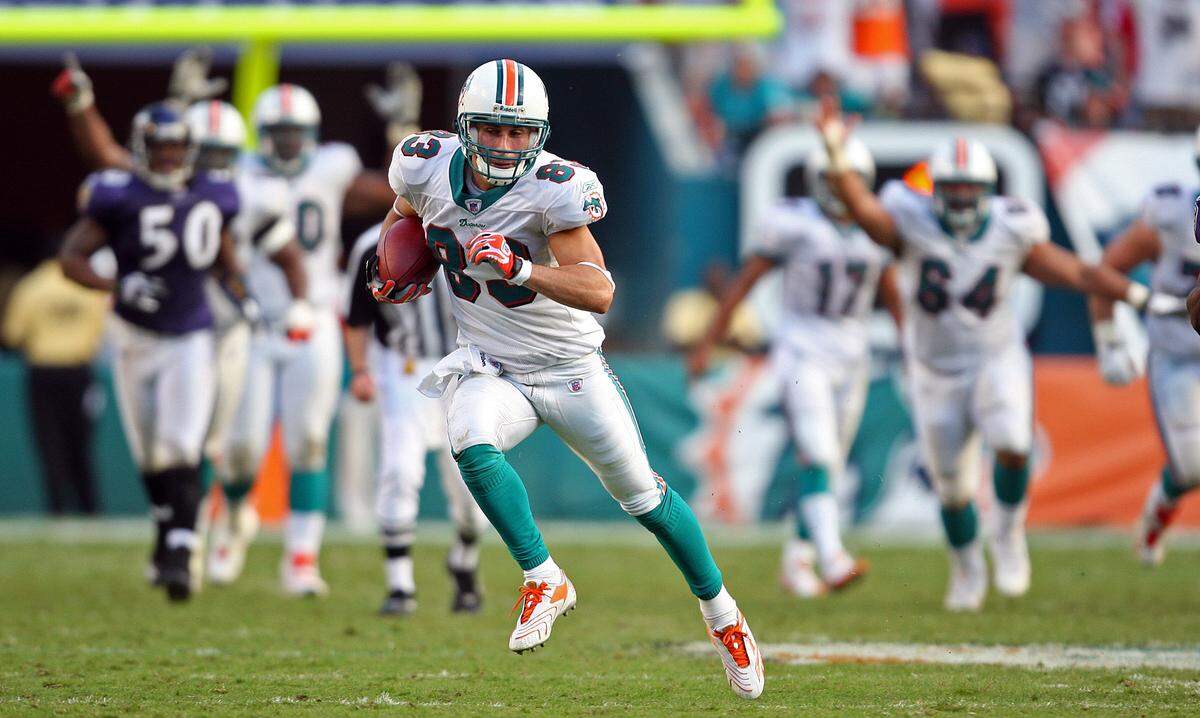 The Miami Dolphins host the Baltimore Ravens at Dolphin Stadium in Miami on Dec. 16, 2007. As his teammates signal touchdown,Dolphins wide receiver Greg Camarillo runs free with his winning touchdown catch in overtime.