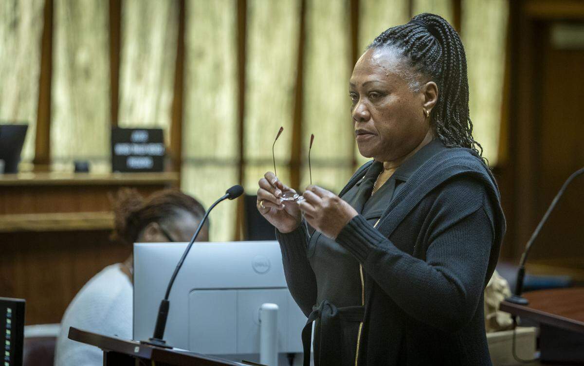 Miami, FL, October 28, 2025 - Charlie Postell, mother of Marlin Barnes, greets jurors before reading her impact statement in court. Jurors will decide if Labrant Dennis, convicted of fatally bludgeoning his ex-girlfriend Timwanika Lumpkins and Barnes, a UM football player Lumpkins was seeing, will be sent back to Florida’s Death Row.
