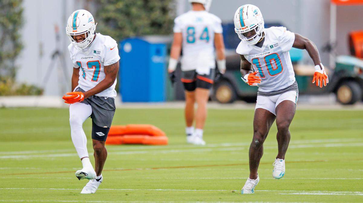 Miami Dolphins wide receiver Jaylen Waddle (17) and teammate Tyreek Hill (10) dance during NFL football training camp at Baptist Health Training Complex in Hard Rock Stadium on Monday, September 5, 2022 in Miami Gardens, Florida.