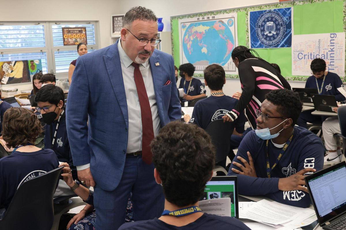 U.S. Secretary of Education Miguel Cardona talks with students of the FBI Cyber Stem Academy at Cypress Bay High School in Weston on Monday, April 4, 2022.