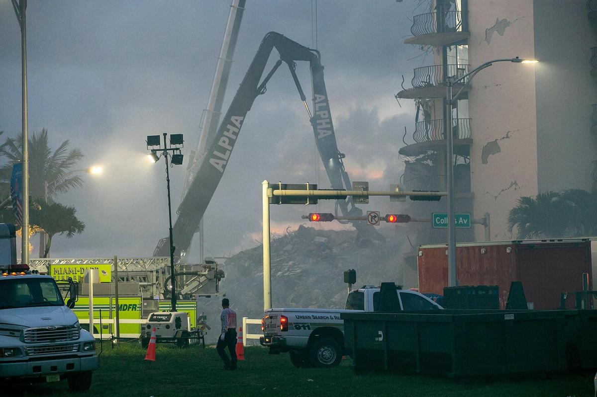 Miami-Dade County Fire Rescue crews uses heavy machinery early Saturday morning as the search and rescue continue at the Champlain Towers South Condo, located at 8777 Collins Avenue in Surfside, that collapsed Thursday morning, on Saturday, June 26, 2021.
