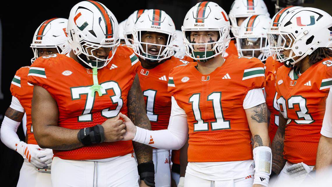Miami Hurricanes quarterback Carson Beck (11) prepares to run out onto the field with teammates before the start of the NCAA game against the NC State Wolfpack at Hard Rock Stadium in Miami Gardens, Florida, on Saturday, November 15, 2025.