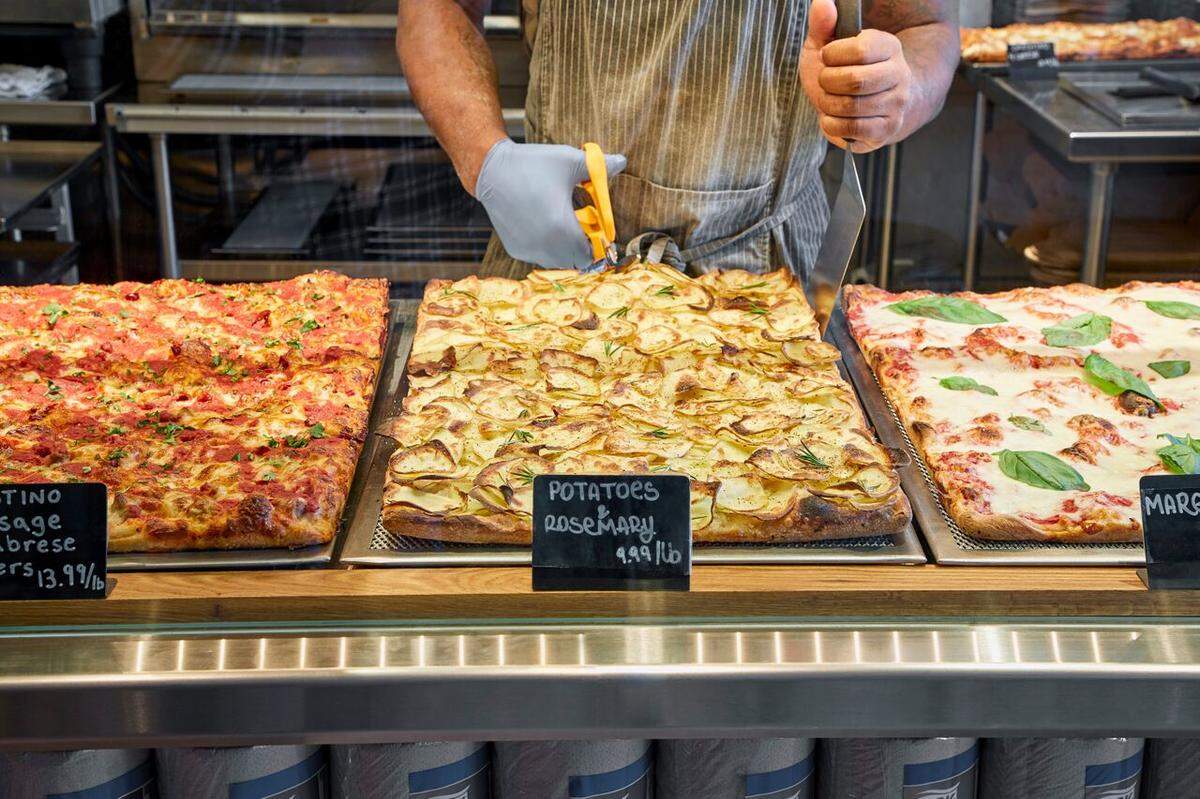 The pizzas are cut into squares with scissors at Bonci Pizza in Wynwood.