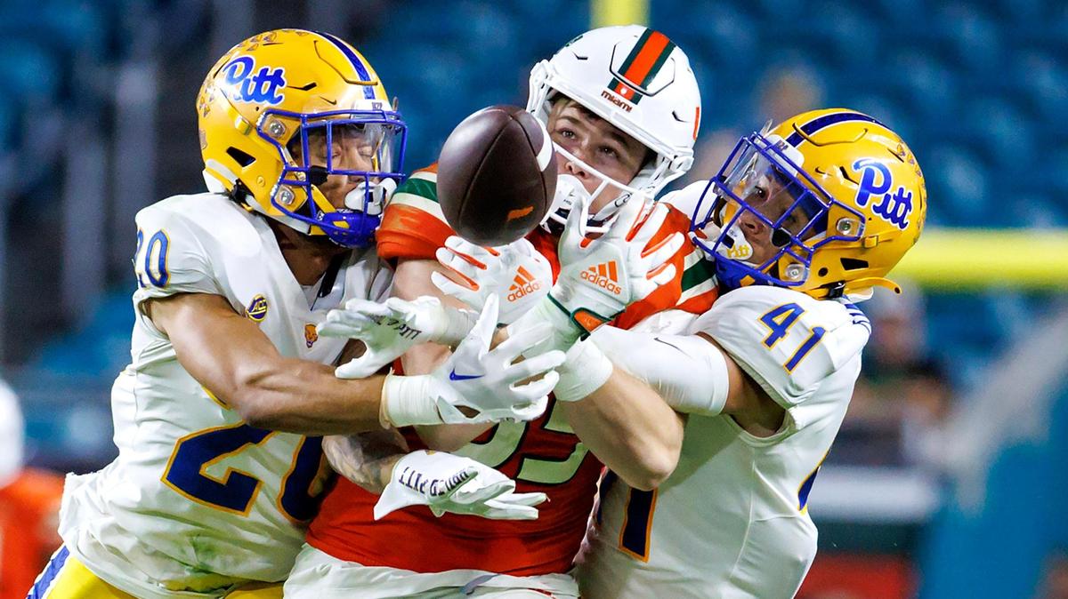 Pittsburgh Panthers defensive back Javon McIntyre (20) and teammate Jehvonn Lewis (41) break a pass intended to Miami Hurricanes tight end Will Mallory (85) during the fourth quarter of an ACC conference football game at Hard Rock Stadium on Saturday, November 26, 2022 in Miami Gardens, Florida.