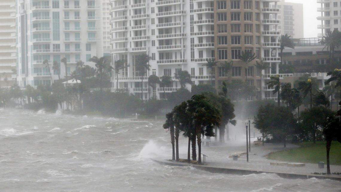 In this Sept. 10, 2017, photo, waves crash over a seawall at the mouth of the Miami River from Biscayne Bay, Fla., as Hurricane Irma passes by in Miami. Rising sea levels and fierce storms have failed to stop relentless population growth along U.S. coasts in recent years, a new Associated Press analysis shows. The latest punishing hurricanes scored bull's-eyes on two of the country's fastest growing regions: coastal Texas around Houston and resort areas of Southwest Florida.