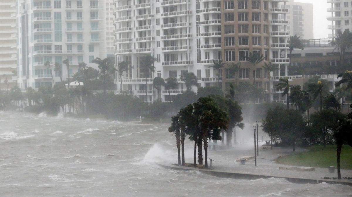 In this Sept. 10, 2017, photo, waves crash over a seawall at the mouth of the Miami River from Biscayne Bay, Fla., as Hurricane Irma passes by in Miami. Rising sea levels and fierce storms have failed to stop relentless population growth along U.S. coasts in recent years, a new Associated Press analysis shows. The latest punishing hurricanes scored bull's-eyes on two of the country's fastest growing regions: coastal Texas around Houston and resort areas of Southwest Florida.