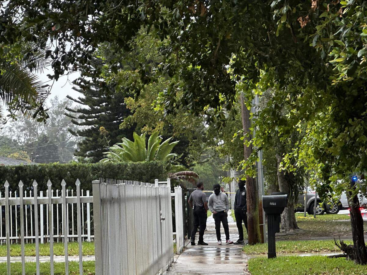 Detectives investigate a double murder in Miami Gardens on Tuesday morning.