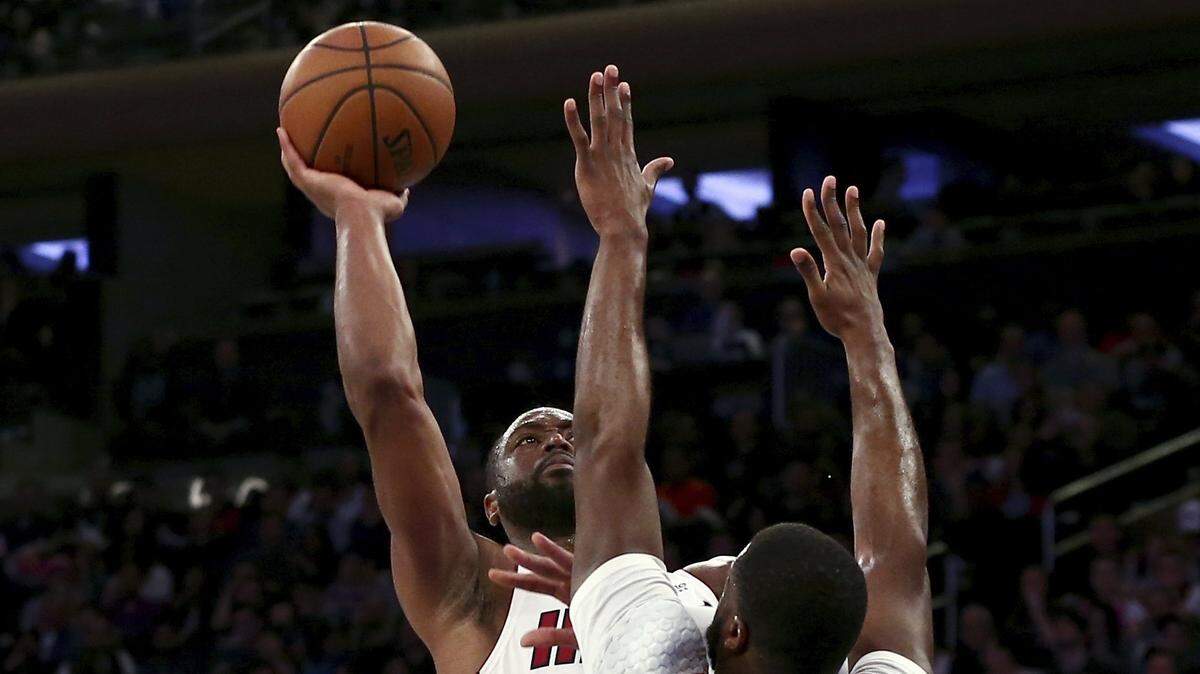 Miami Heat’s Dwyane Wade shoots over New York Knicks’ Emmanuel Mudiay during the first half of an NBA basketball game Saturday, March 30, 2019, in New York. (AP Photo/Nicole Sweet)