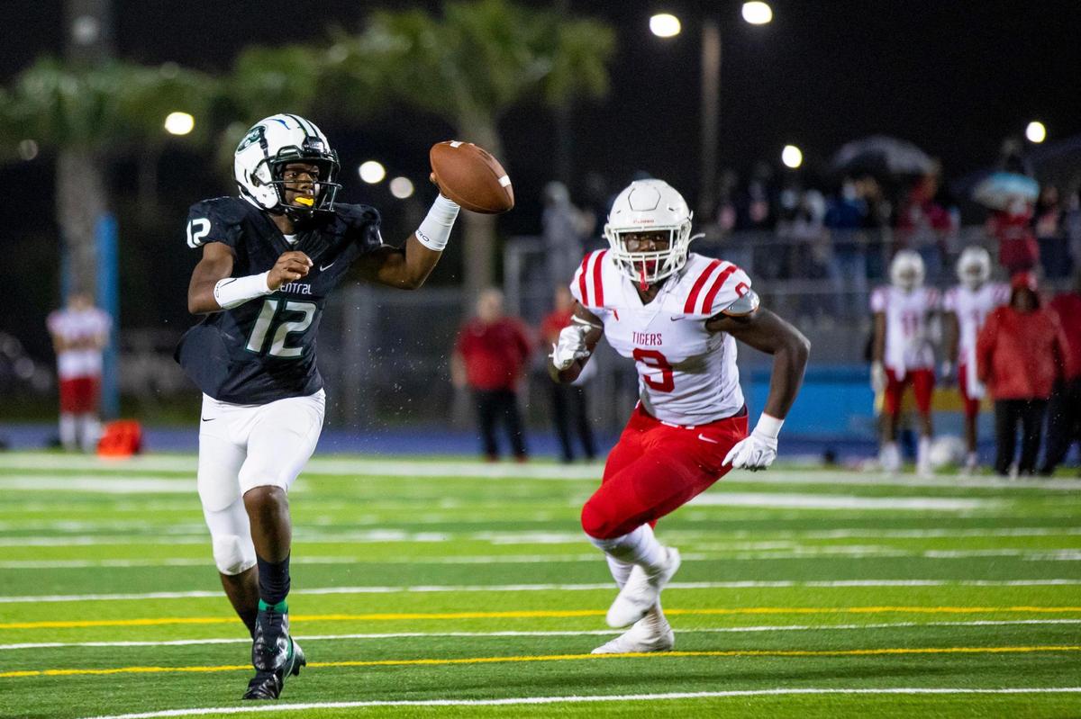 Miami Central High School quarterback Keyone Jenkins (12) looks to throw down field as Palmetto Ft. Myers middle linebacker Alonzo Houston (9) attempts to sack him during a Class 6A high school football state semifinal at Traz Powell Stadium in Miami, Florida, on Friday, December 11, 2020.