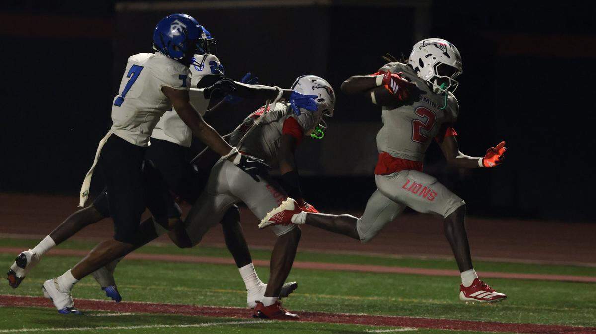 Chaminade-Madonna Lions running back Arwin Jackson (2) carries the football for a touchdown against Trinity Christian Academy during the second half of a Class 1A football state semifinal game at Chaminade-Madonna College Preparatory on Friday, Dec. 5, 2025 in Hollywood, Fla.