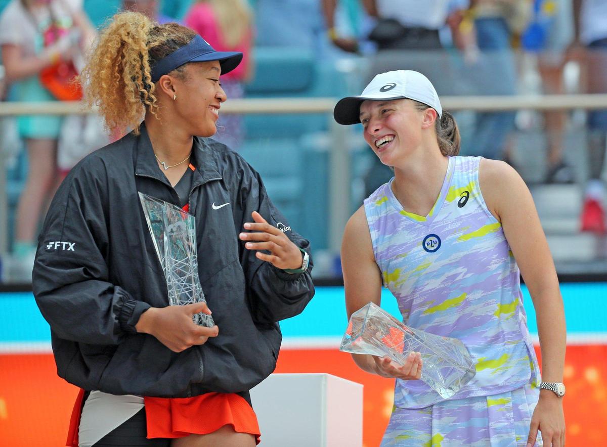 Iga Swiatek and Naomi Osaka receive their trophies after Swiatek defeats Osaka during the Miami Open Women’s Final at Hard Rock Stadium in Miami Gardens, Florida on Saturday, April 2, 2022.