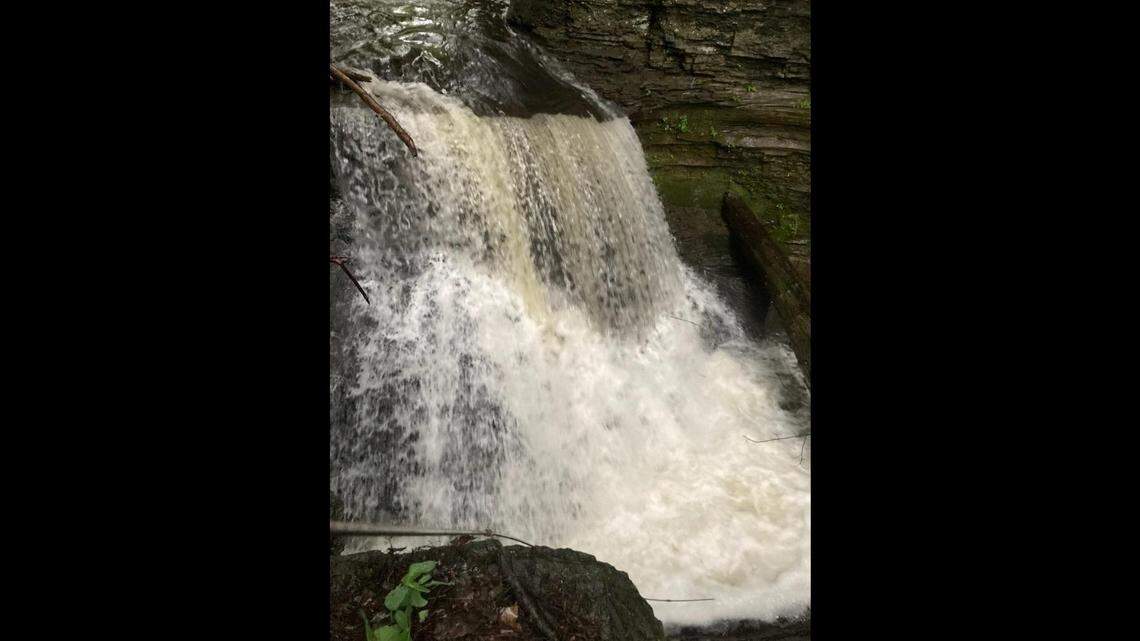 Two people drowned in a Newfield, New York, waterfall after one tried to rescue the other, officials say. Children flagged down a passerby for help.