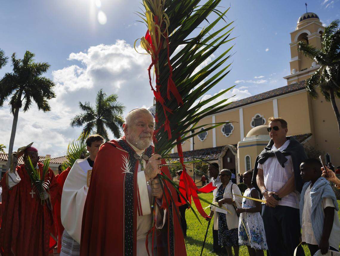 Archbishop Thomas Wenski, center, processes past the crowd towards the cathedral after the traditional blessing of the palms before Palm Sunday Mass on Sunday, March 29, 2026, at the Cathedral of St. Mary in Miami, Fla. “It is easy for us to say we would’ve done something different than the crowd or Pontius Pilate, but when we are silent in the face of suffering in the world around us [we are complacent],” said the Archbishop in his homily at mass.