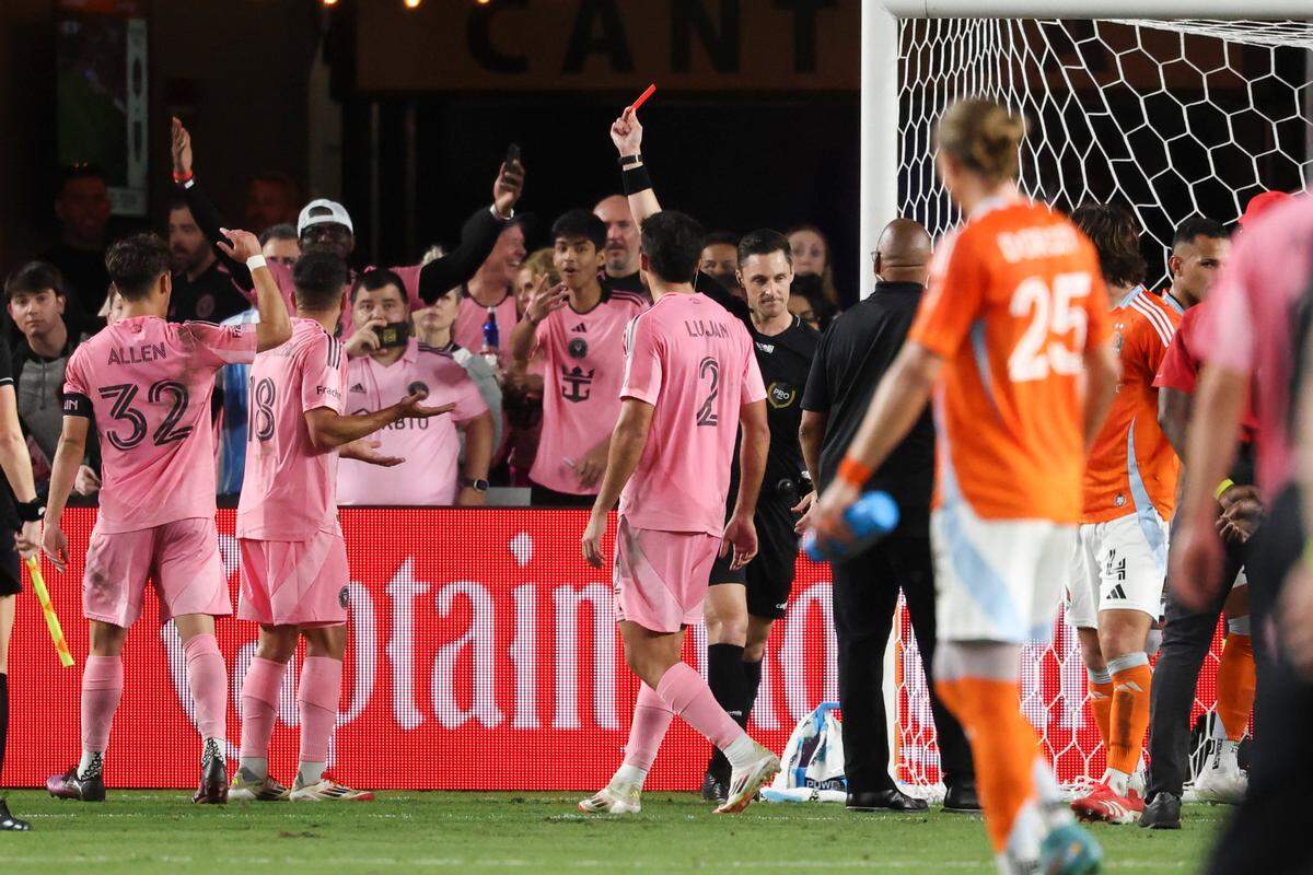 Mar 2, 2025; Houston, Texas, USA; A referee holds a red card after the match between Houston Dynamo FC and Inter Miami CF at Shell Energy Stadium. Mandatory Credit: Troy Taormina-Imagn Images