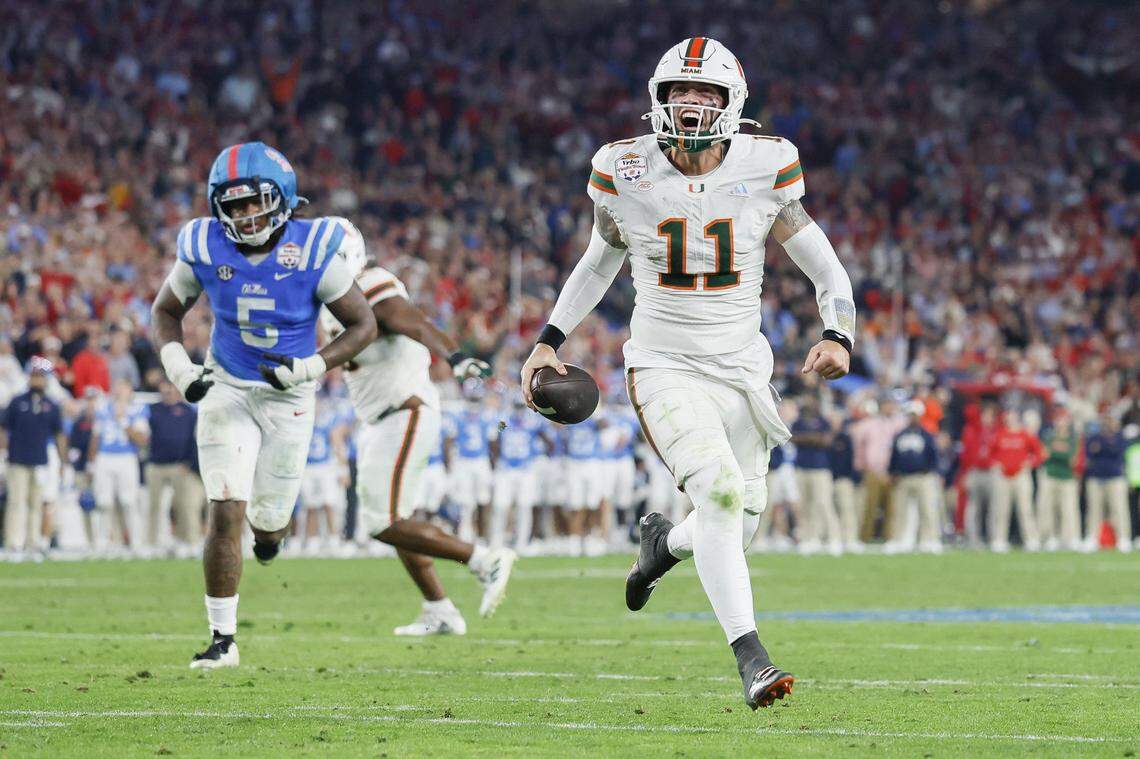 Miami Hurricanes quarterback Carson Beck (11) and teammates celebrate after scoring during the second half of a College Football Playoff semifinal against the Mississippi Rebels in the Fiesta Bowl at State Farm Stadium on Friday, January 9, 2026 in Glendale, Arizona.