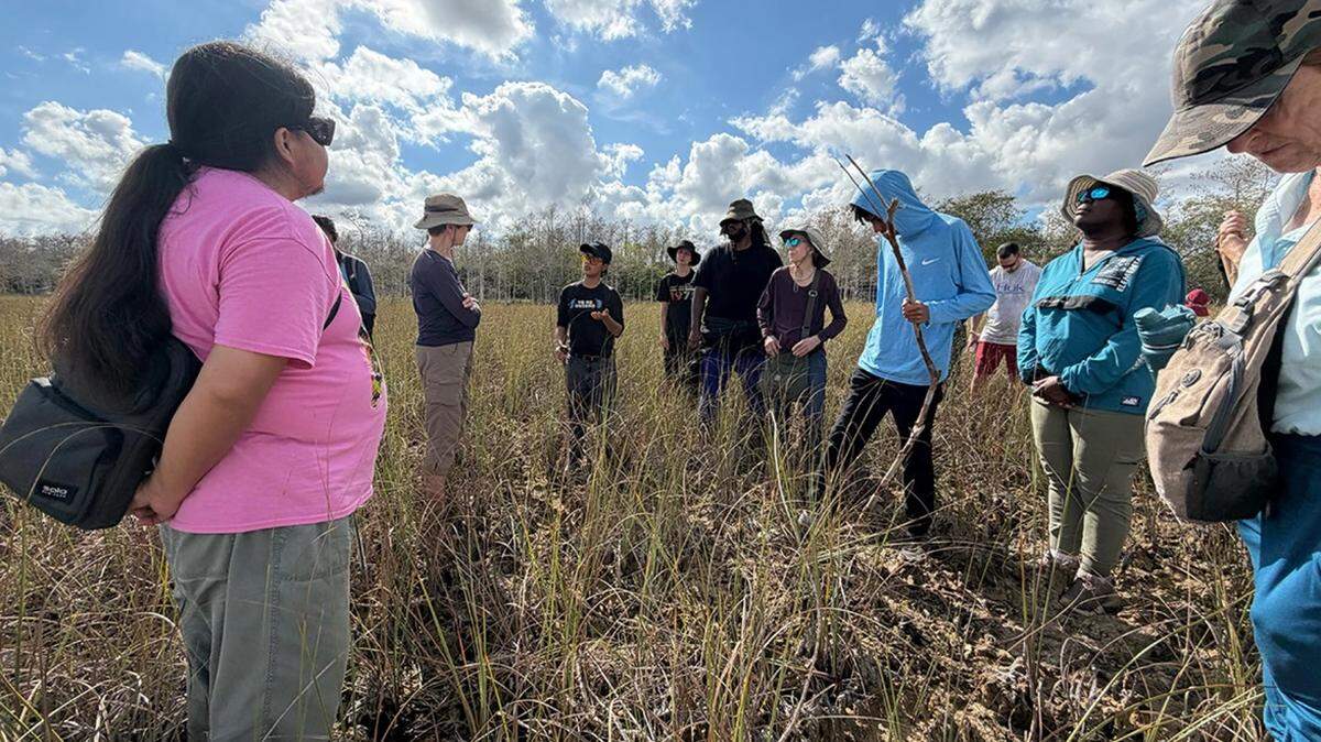 Houston R. Cypress, left, speaks about the medicinal qualities of Everglades plant life to walk participants in the Everglades on Jan. 27, 2026.