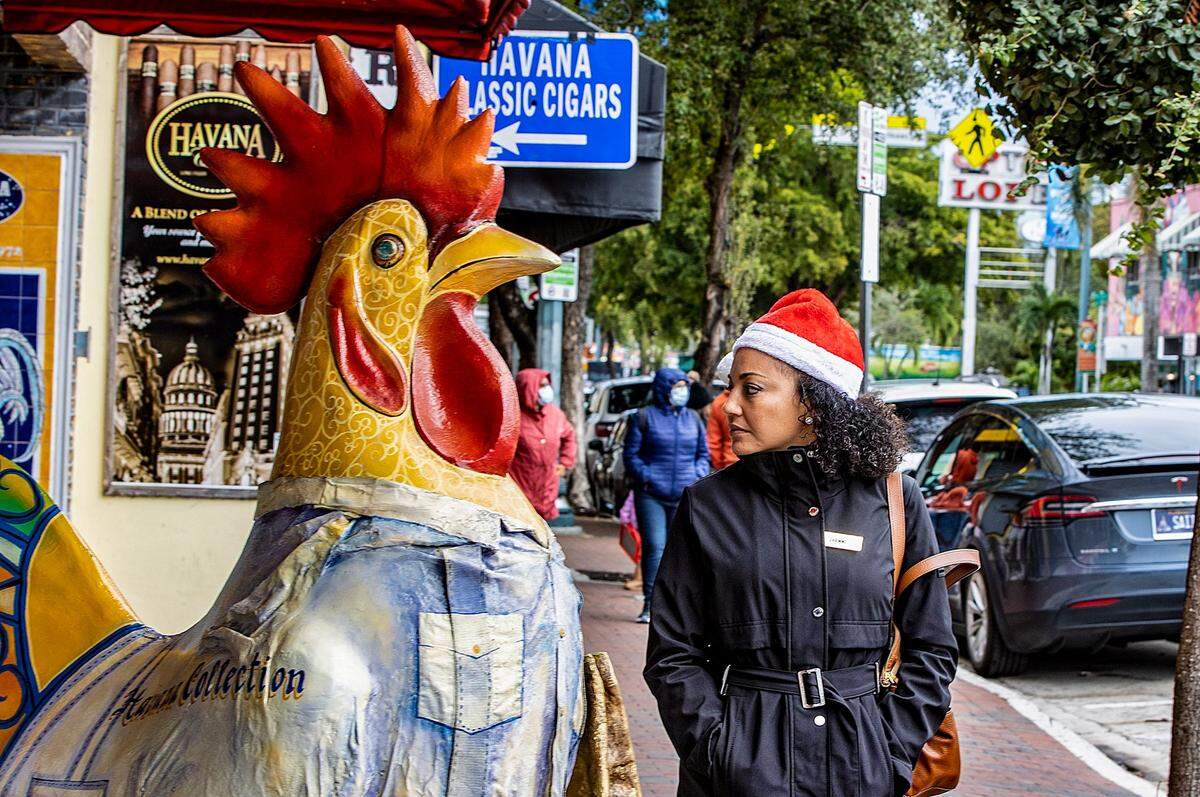 The cold temperatures in Miami on Christmas Day didn’t stop Jenny Perez of Miami from taking a walk along Calle Ocho in Little Havana, as the cold temperatures affecting Florida continue through the holiday weekend, on Sunday, Dec, 25, 2022.