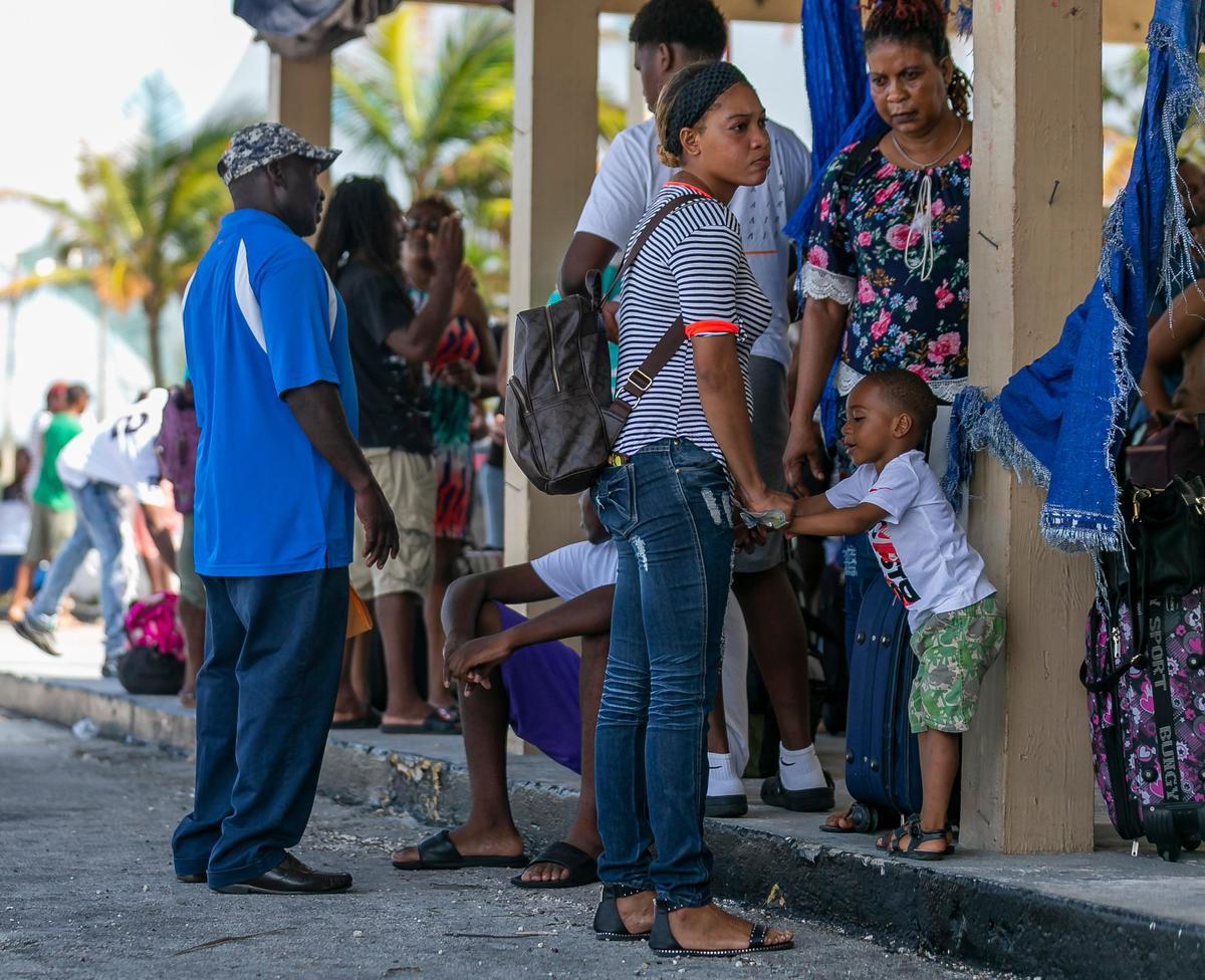 Hundreds of people waited under the hot sun for hours trying to board a ship at the Freeport Harbour in Grand Bahama Island on Friday, Sept. 6, 2019.