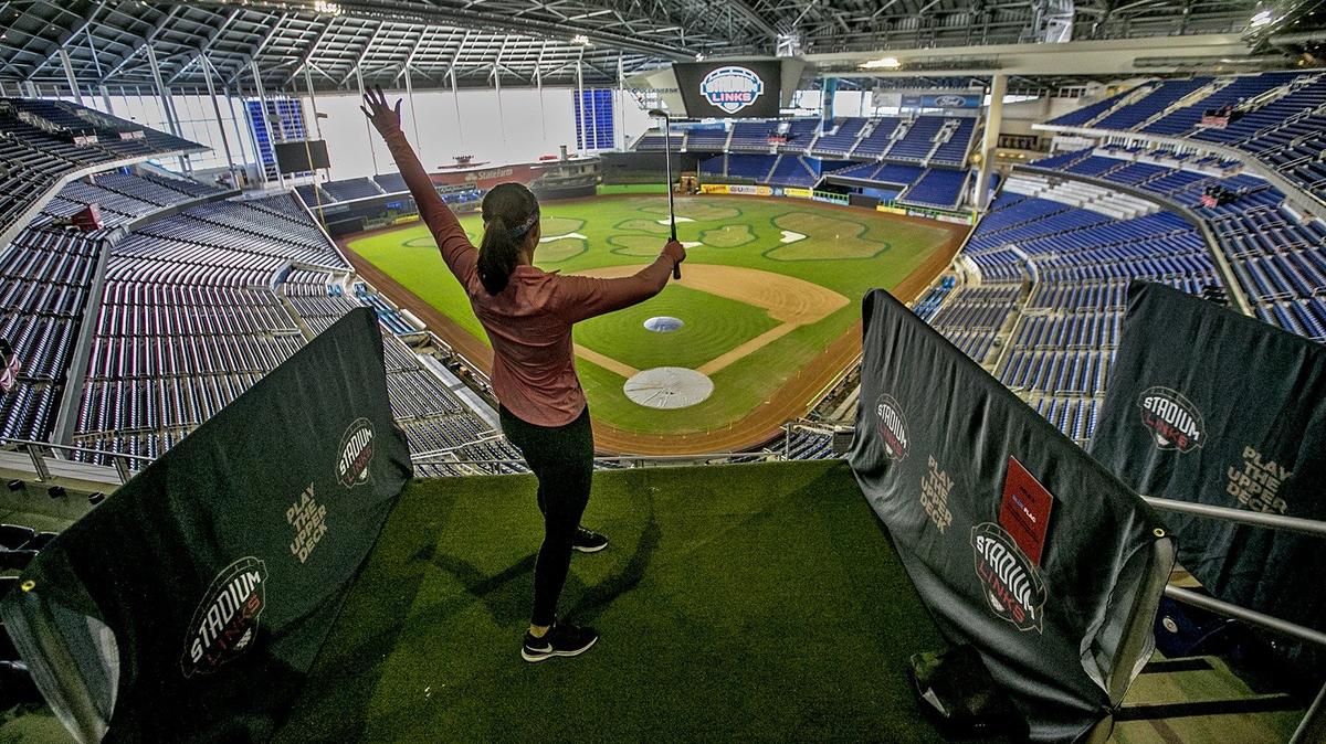 Jaclyn Mendiguren of West Palm Beach throws her arms in the air after hitting a nice final shot on the ninth hole of the Stadium Links venue at Marlins Park on Sunday, January 20, 2019.