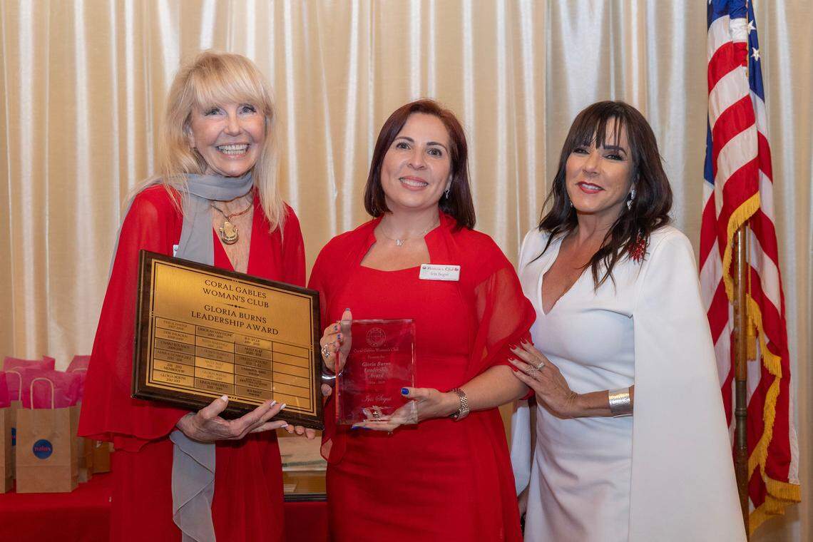 Gloria Burns presents the Coral Gables Woman’s Club Gloria Burns Leadership Award to Iris Segui along with Club President Arely Ruiz at the club’s annual ceremony.