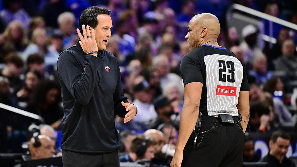 Head coach Erik Spoelstra of the Miami Heat talks with referee Tre Maddox #23 in the first half of a Emirates NBA Cup Quarterfinals game against the Orlando Magic at Kia Center on December 09, 2025 in Orlando.